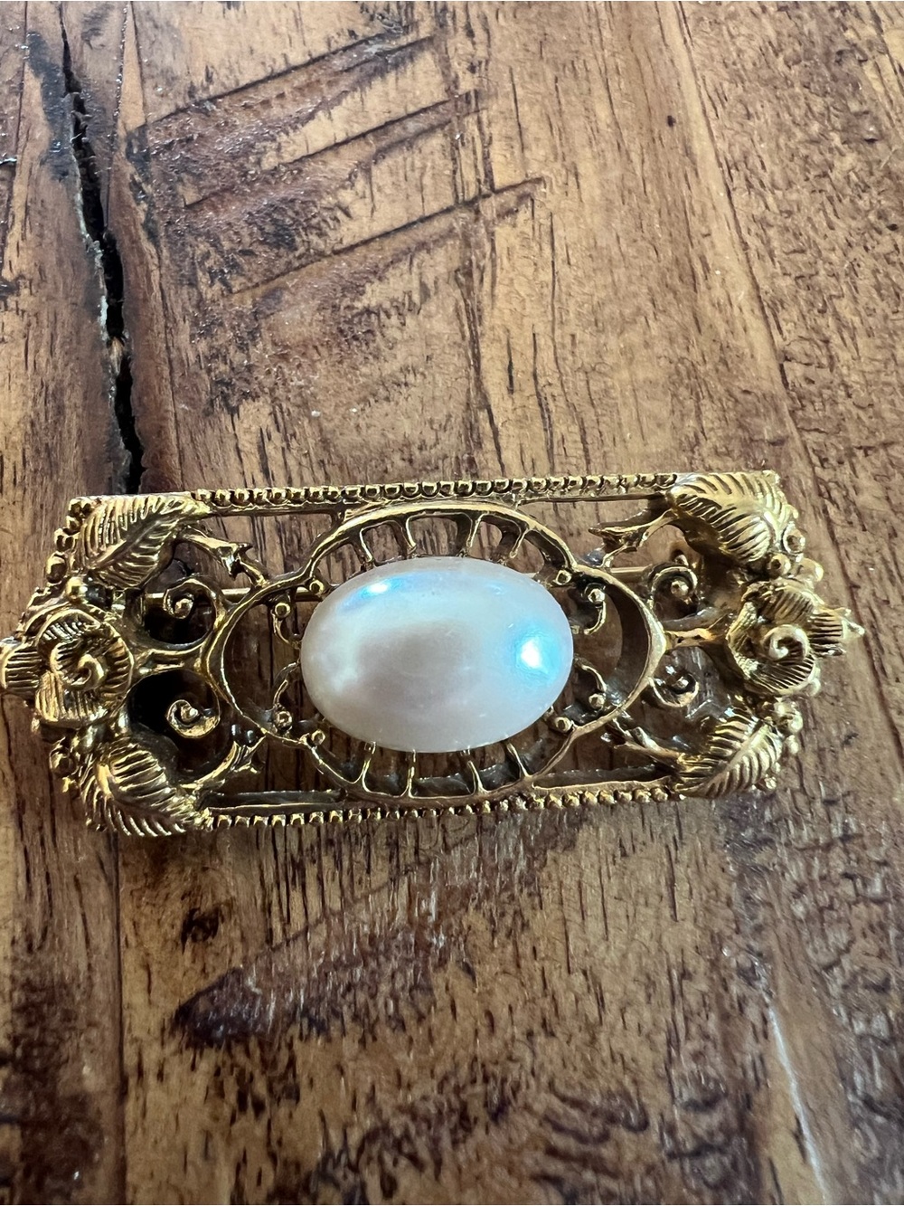Gold-Tone Filigree Brooch with Pearl Cabochon.
